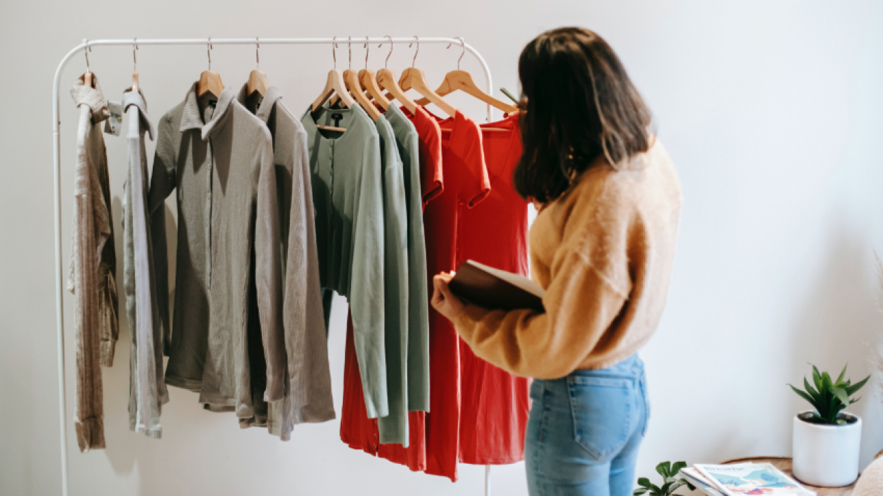 woman looking through clothes rack