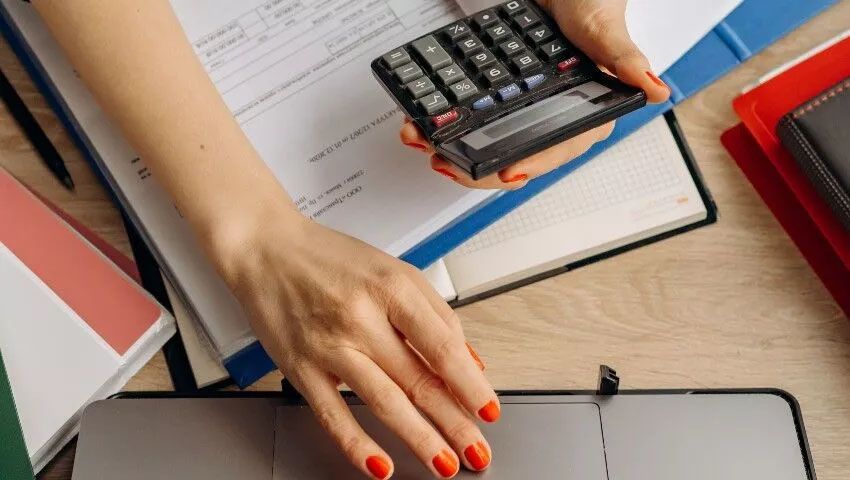 Woman's hands using calculator